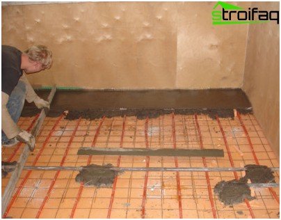 Pouring concrete mixture over a layer of mineral wool and reinforcing mesh