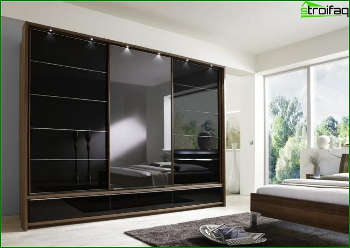 Glidende garderobe i et soveværelse med et spejl